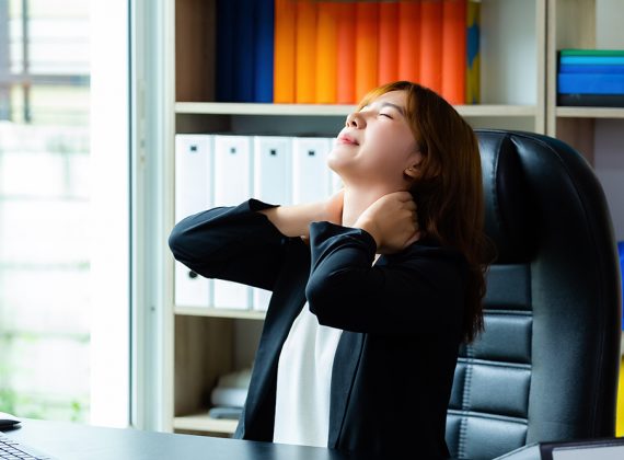 Young working woman has neck pain and tired because work hard in the office