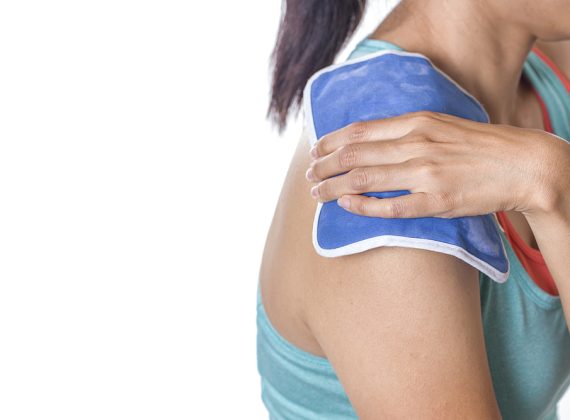 Woman,Putting,An,Ice,Pack,On,Her,Shoulder,Pain
